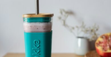 teal and white plastic cup on brown wooden table